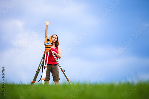 Young female land surveyor at work