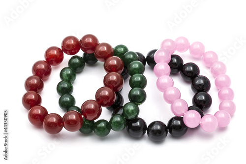 Colorful bead bracelets isolated on white