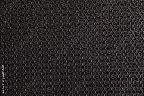 Black speaker grill, metal background, abstract texture.