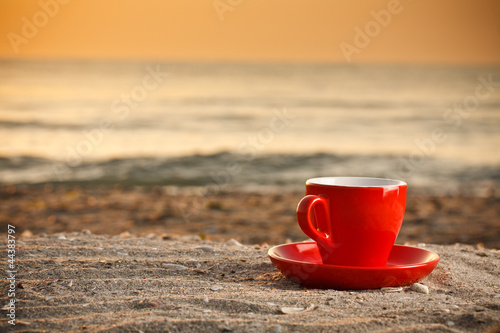 Coffee cup on beach