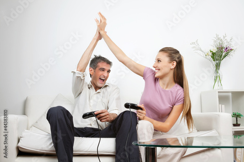 Happy Couple Playing Video Game At Home