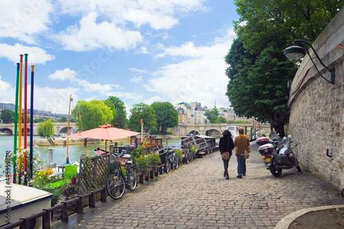 Tourists walking along the embankment of the Seine, Paris