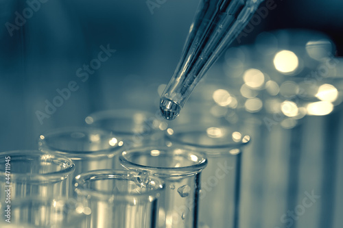 Pipette adding fluid to one of several test tubes