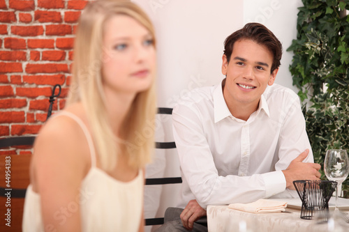 Man admiring blond woman in restaurant