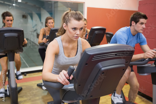 People working out at spinning class