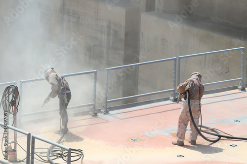 Sandblasting of metal structures at construction site