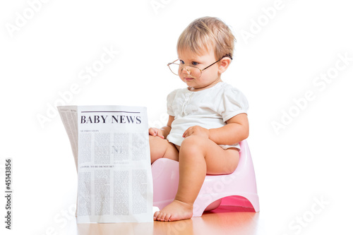 funny baby girl reading newspaper on chamberpot