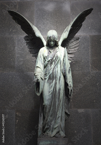 Monument of old angel on cemetery in Warsaw