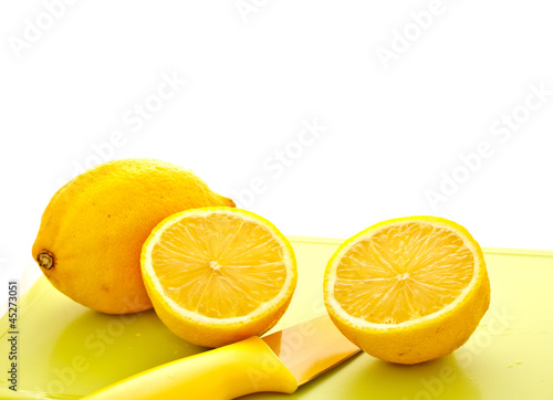 cut lemon with knife on white background
