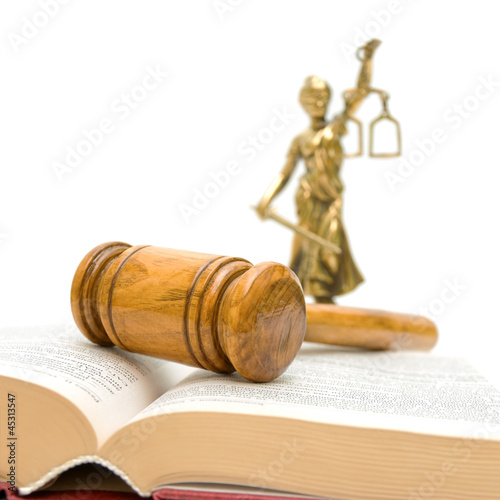 gavel, law book, a statue of justice on a white background