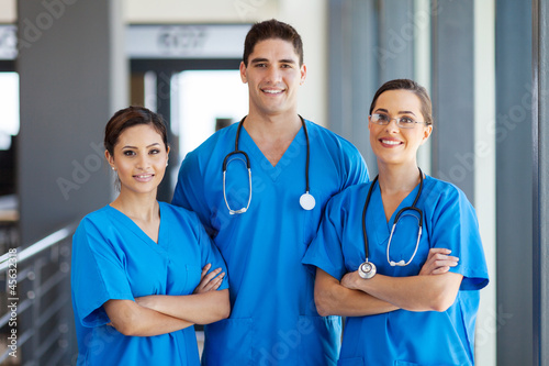 group of young hospital workers in scrubs