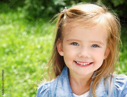 Outdoor portrait of smiling little girl