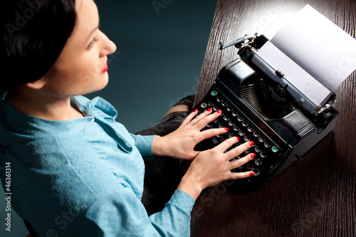 Young woman typing with old typewriter