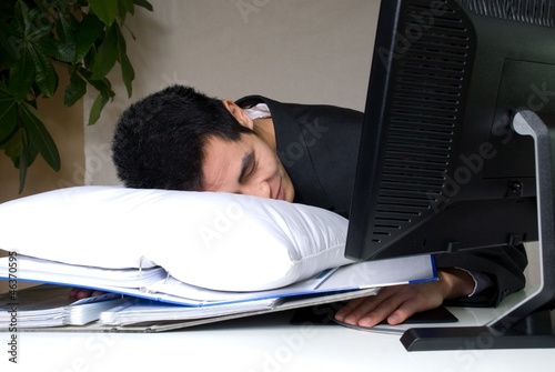 man sleeping on his desk