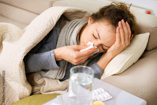 Sick Woman. Flu. Woman Caught Cold. Sneezing into Tissue