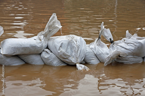 sandbags for flood defense and brown water