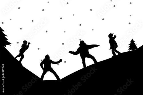 Family in a snowball fight in winter in mountain silhouette