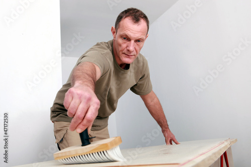 Man sweeping a wooden surface