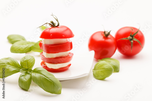 tomato and mozzarella slices decorated with basil leaves