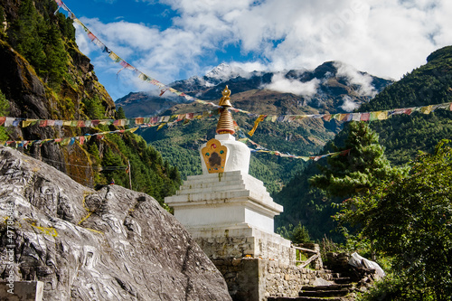 Buddhism: stupe or chorten with prayer flags in Himalayas