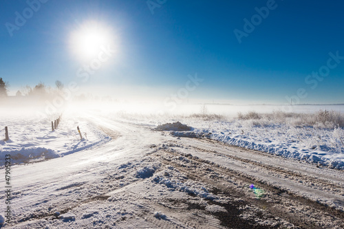 winter landscape at fog with road