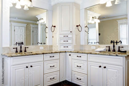 Luxury large white master bathroom cabinets with double sinks.