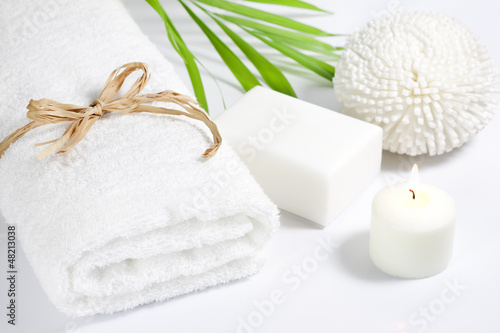 Towel and sponge spa bath concept on white background