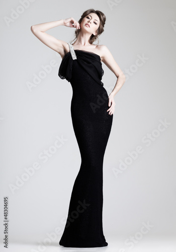 beautiful woman model posing in elegant dress in the studio