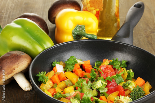 Sliced fresh vegetables in pan with spices and ingredients