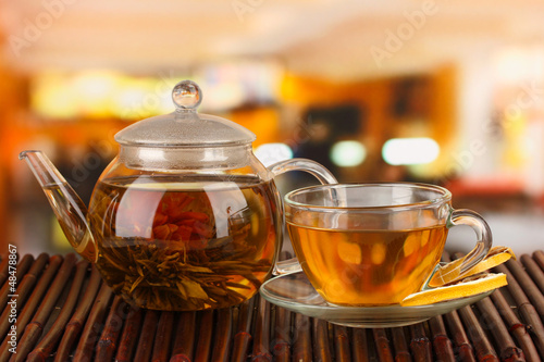 Exotic green tea with flowers in glass teapot