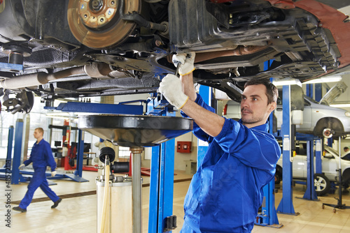 auto mechanic at car suspension repair work