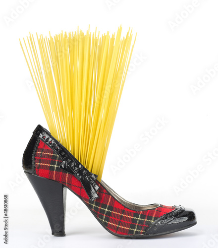 Portion of uncooked spaghetti in the Scottish heeled shoe