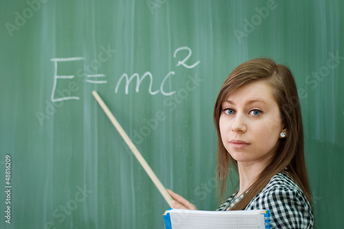Student girl showing e=mc2 formula