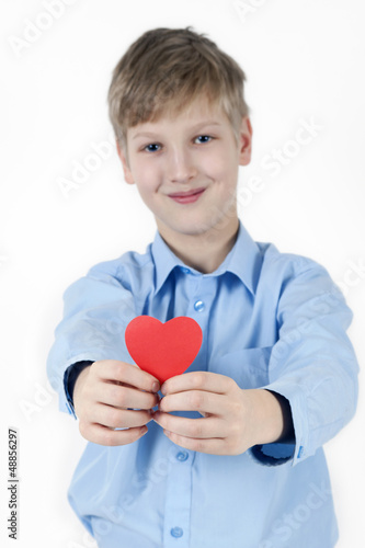 Smiling boy and red heart. Valentines Day concept.