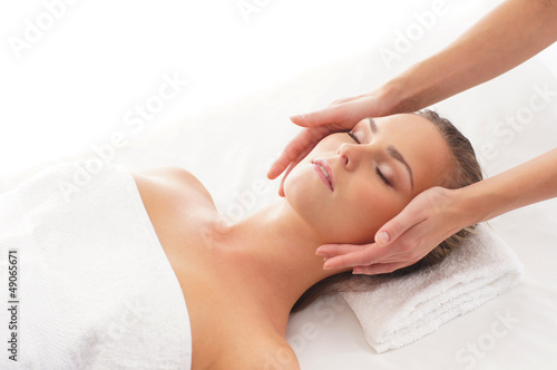 Portrait of a young woman relaxing on a spa massage