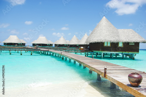 Water villas on tropical island on Maldives
