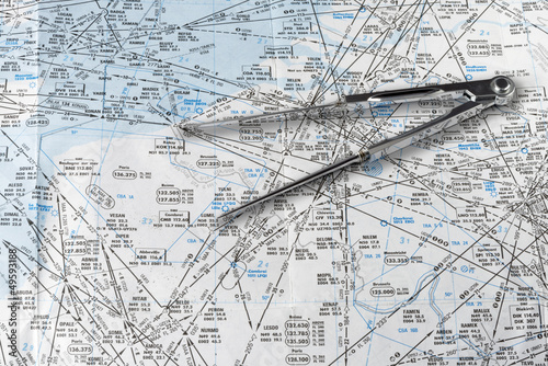 A pair of compasses on an aeronautical navigational chart