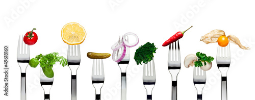 Variety of vegetarian food on forks isolated on white