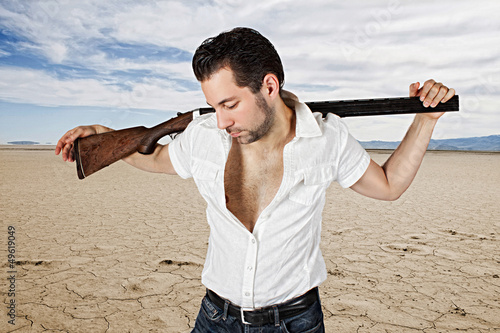 man with gun in desert