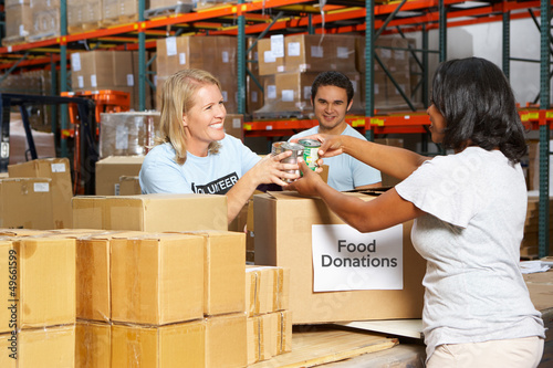 Volunteers Collecting Food Donations In Warehouse