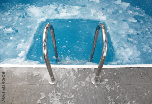 Steps in the frozen blue pool ice-hole