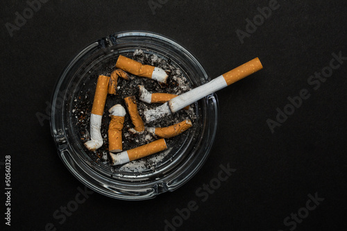 Burning cigarette left in ashtray