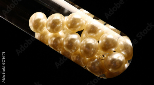 Test tube with white pearls