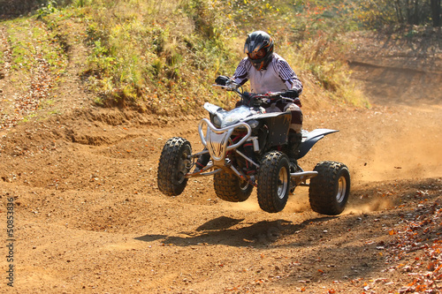 Quad motorbike rider jumps