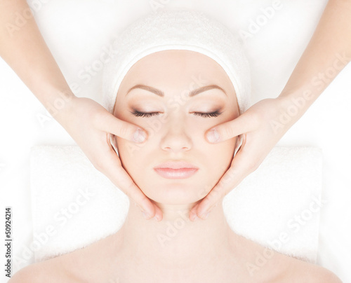 Portrait of a young woman relaxing on a spa massage