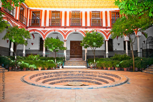 Typical andalusian courtyard with fountain, Seville, Spain.