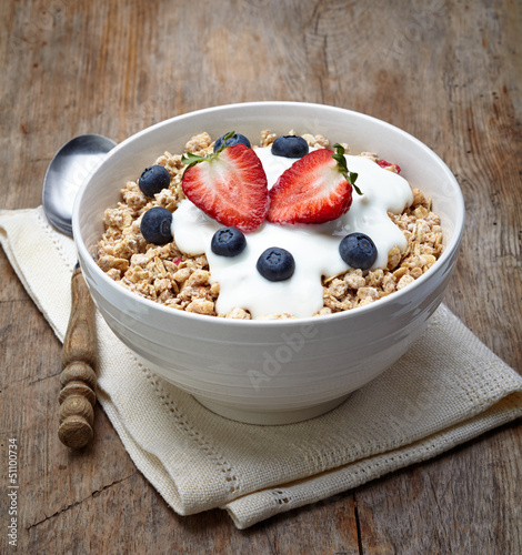 Bowl of healthy muesli with yogurt and fresh berries