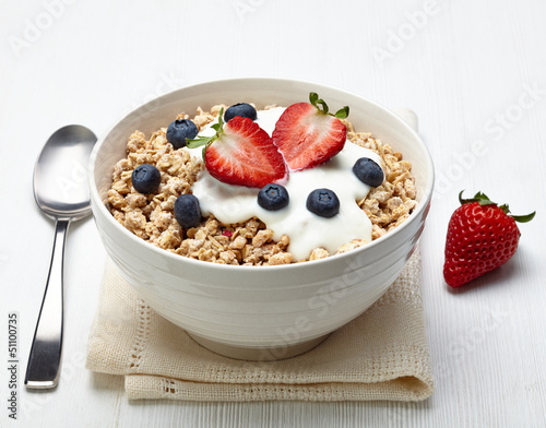 Bowl of healthy muesli with yogurt and fresh berries