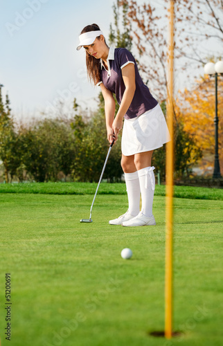 Attractive girl playing golf