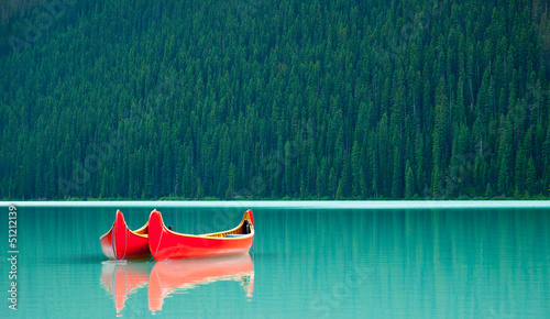 Canoes floating peacufully on Lake Louise near Banff.